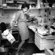 Wendy Tokuda works during a busy day at KPIX in 1990. According to the photo caption, she's returning calls, and the bear is from a young fan. (Credit: Liz Hafalia/San Francisco Chronicle)